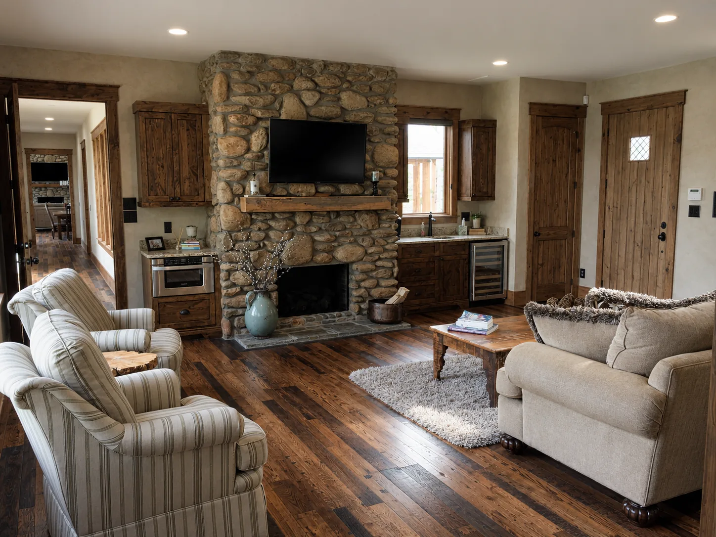 Living room with stone fireplace in a custom home built by Higgins Building Group in Western North Carolina